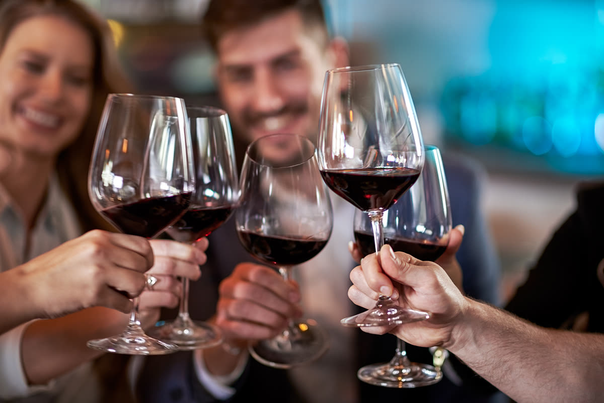 A toast over glasses of red wine