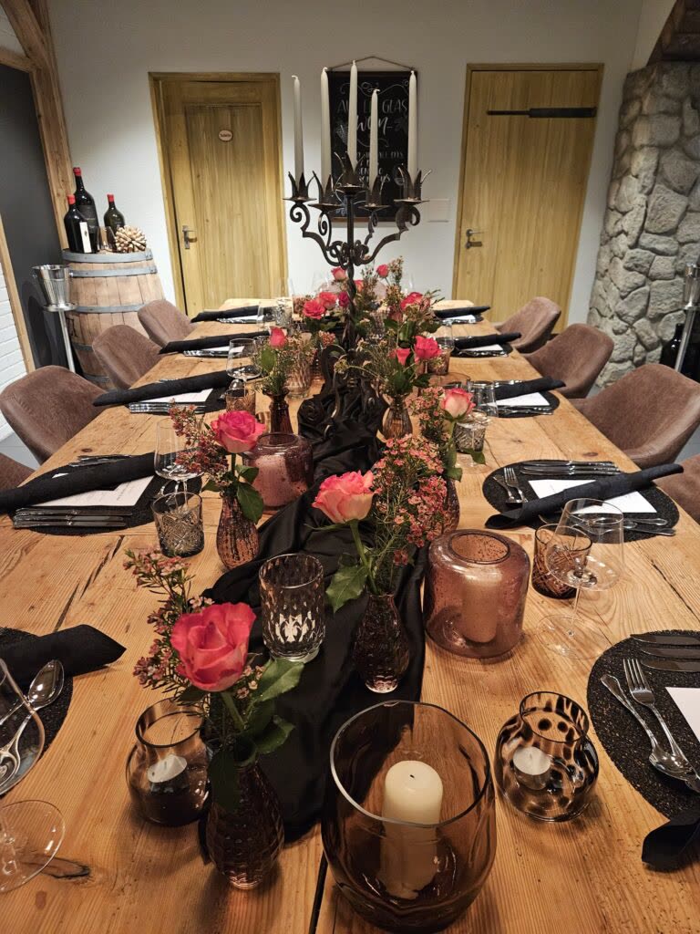 The long table, laid with roses and candles